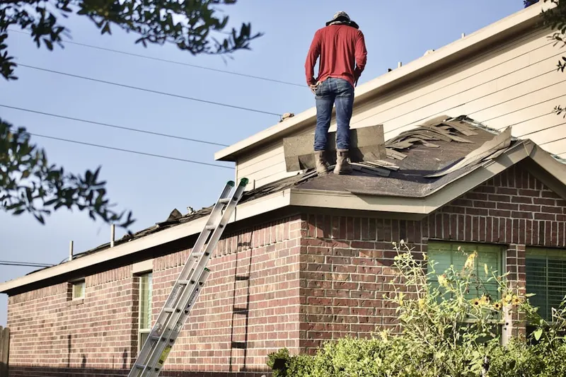 Professional roofer working on a residential roof in Lynnewood Gardens